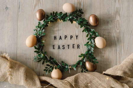 Happy Easter. Easter eggs and and green wreath. Congratulatory easter background.の写真素材