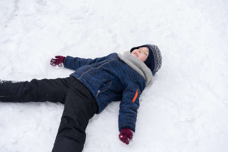 Little boy playing with snow. Winter holiday.の写真素材