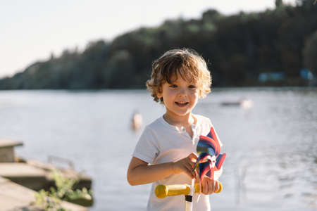 Portrait of a cute boy playing in nature near the river.の写真素材