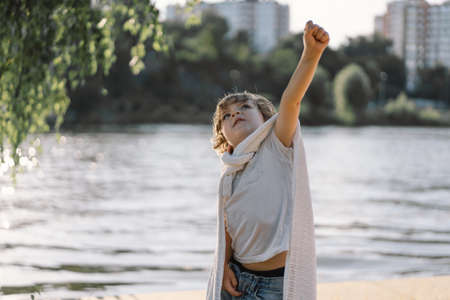 Portrait of a cute boy playing in nature near the river.の写真素材