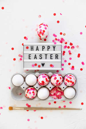 Happy Easter. Easter eggs decoration pink paper confetti.の写真素材
