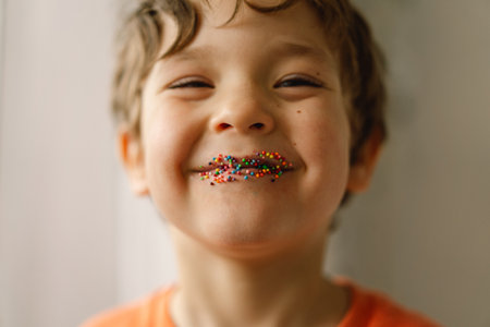 Happy Easter. Cute boy eats and plays with Easter sprinkles.の写真素材