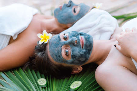 Beautiful Women getting facial care. Wellness, healing and spa relaxation concept.の写真素材