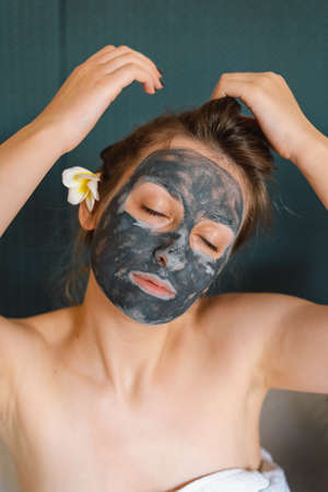 Beautiful woman applying facial mask. Wellness, healing and spa relaxation concept. Cosmetic. Lifestyleの写真素材