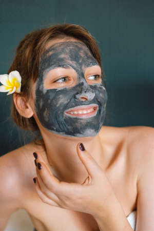 Beautiful woman applying facial mask. Wellness, healing and spa relaxation concept. Cosmetic. Lifestyleの写真素材