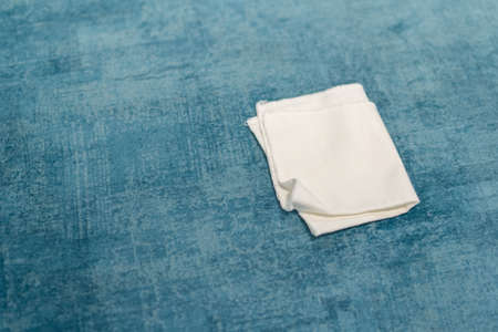Woman cleaning a blue sofa with white cloth. Sofa cleaning. Removing stains.の写真素材