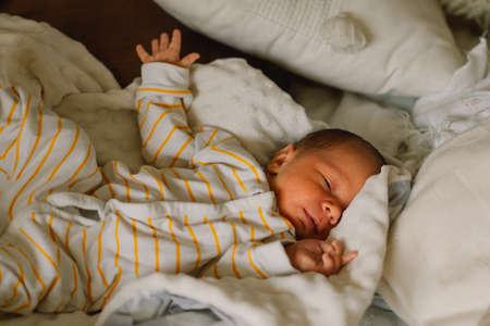 Cute newborn little baby boy sleeping in crib. Infant babyの写真素材