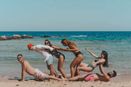 Group of friends having fun at the beachの写真素材