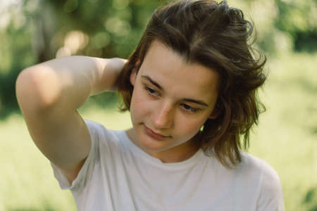 Beautiful young Teenager Girl with a trendy bob hair in a white t-shirt in a outdoor and looking at camera.の写真素材