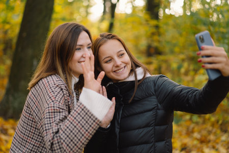 Young girls laughs and talking by video call on the phone. The concept of lifestyle mobilityの写真素材