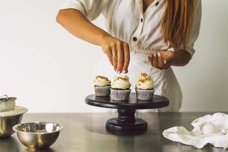 Confectioner girl is preparing a cupcakes. Concept ingredients for cooking flour products or dessert