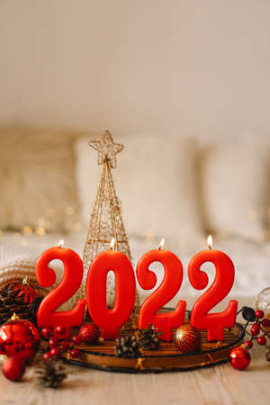 Happy New Years 2022. Numbers of year 2022 made by red candles on bokeh festive sparkling backgroundの写真素材