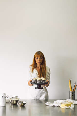 Confectioner girl is preparing a cupcakes. Concept ingredients for cooking flour products or dessert