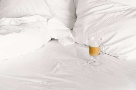 Breakfast on the bed in the hotel room. Breakfast in a snow-white bed with coffeeの写真素材