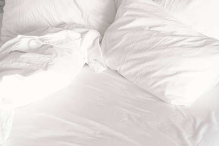 White comfort bed and soft pillow in bedroom. White blanket in hotel bedroom.の写真素材