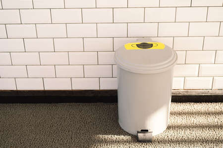 Mask to the Trash Can. Throw Away Used Mask. Trash Bin with Medical Waste. Medical Mask After Useの写真素材
