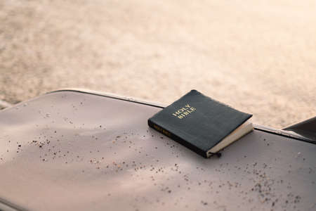 Holy Bible lies on a sun lounger by the sea. Reading the Holy Bible. Concept for faithの写真素材