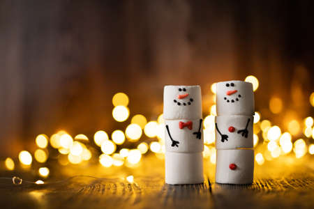 Marshmallow best friends. Two funny marshmallow snowmen. Christmas winter holiday decoration.