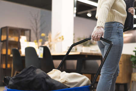 Young woman wearing protective gloves in store. Today people lifestyle conceptの写真素材