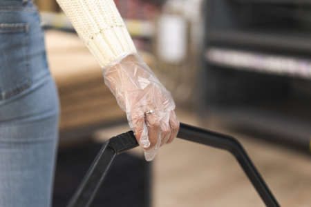 Young woman wearing protective gloves in store. Today people lifestyle conceptの写真素材