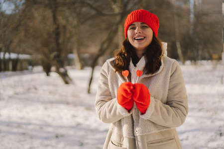Happy valentines day. Young woman posing with Valentines day heart shaped candies and lollipopsの写真素材