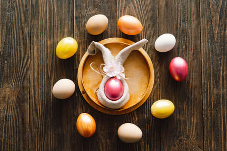 Multicolored Easter eggs on a wooden background.