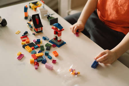 Cute boy is playing constructor at home. Kid playing block toys in home at nursery.の写真素材