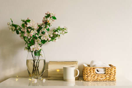 Book, candle and vase with apple spring flowers.の写真素材
