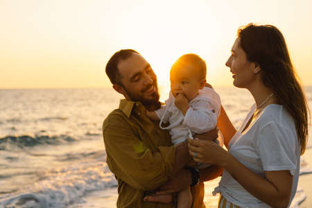 Happy family having fun playing beach in summer vacation on the beach.