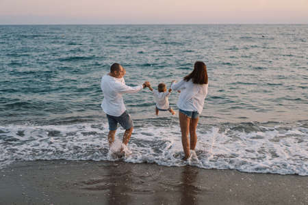Happy family having fun playing beach in summer vacation on the beach.の写真素材
