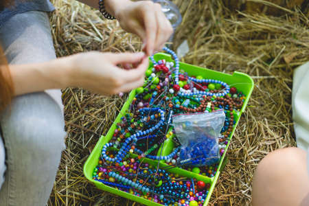 Weaving handmade jewelry, the process of creation. Handmade concept