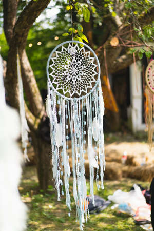 Dreamcatcher hanging on a tree. Boho chic, ethnic amuletの写真素材
