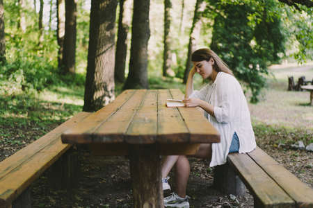 Woman holds book in her hands.の写真素材
