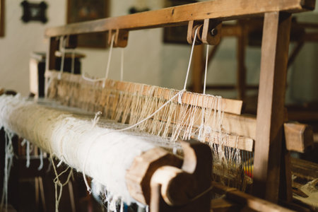 Old wooden hand loom. Ancient weaving loom in interior of wooden log hutの写真素材