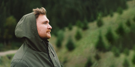 Portrait of Young happy male in the forest. Wellness concept and holistic rest.の写真素材