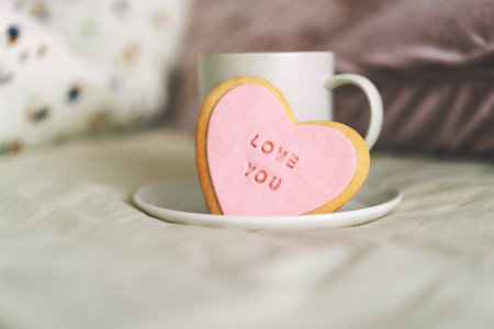A cup of coffee with delicious cookies with the inscription love you.の写真素材