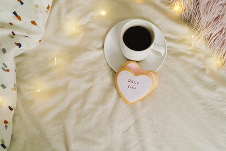 A cup of coffee with delicious cookies with the inscription love you.の写真素材