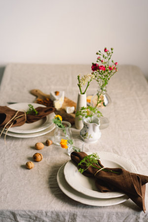 Vintage table setting with Linen napkins and floral decorations. Close up.の写真素材