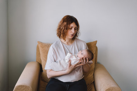 Portrait of happy mum holding infant child on hands.の写真素材