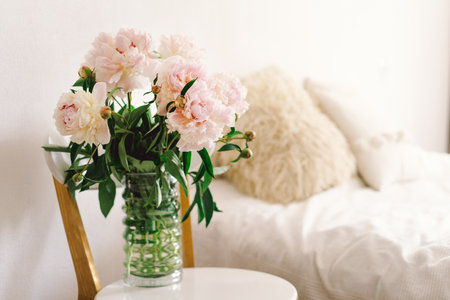 Pink Peonys bouquet on a white chair in the living room.の写真素材