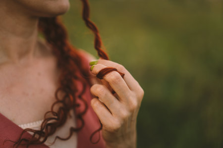 A girl with red curly hair. long hairの写真素材
