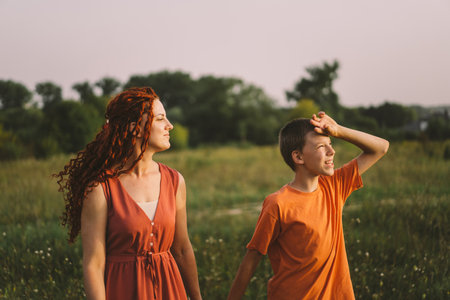Happy mother having fun with her son outdoor. Family and love concept.の写真素材