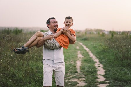 Happy Fathers day. Father with son are walking in the field.の写真素材