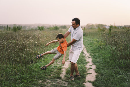 Happy Fathers day. Father with son are walking in the field.の写真素材