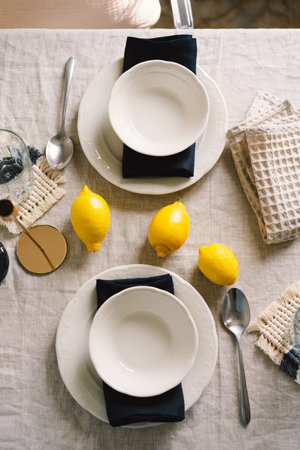 Vintage table setting with Linen napkins and yellow lemons.の写真素材