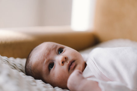 Portrait of a 1 month old baby. Cute newborn baby lying on a developing rug.の写真素材