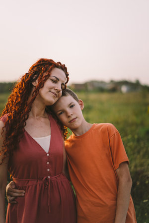 Happy mother having fun with her son outdoor. Family and love concept.の写真素材