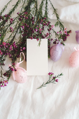 Easter eggs with flowers on white linen fabric.の写真素材