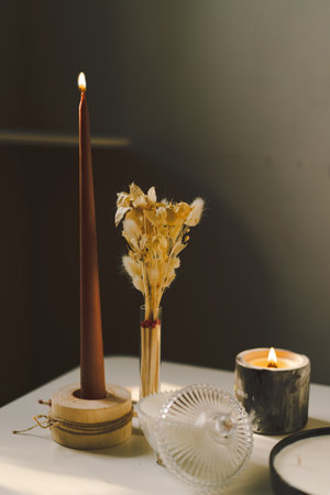Burning candles on table indoors. Cozy homeの写真素材