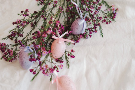 Easter eggs with flowers on white linen fabric.